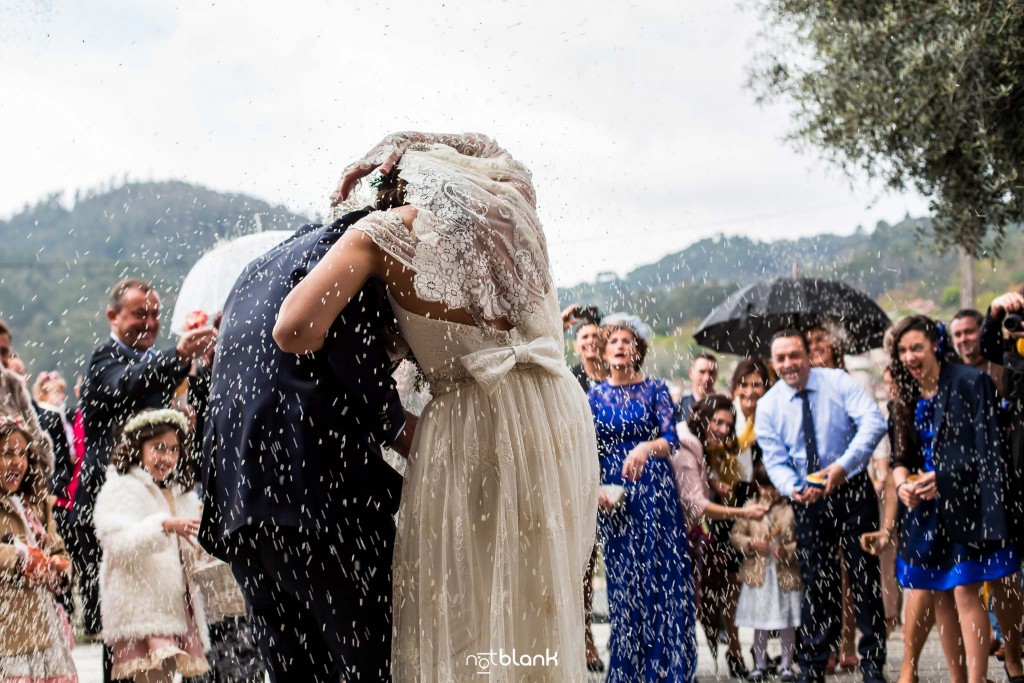 Boda en Salceda de Caselas. Los invitados tiran una gran lluvia de arroz a la salida de los novios de la iglesia. Reportaje realizado por Notblank fotógrafos de boda en Galicia.