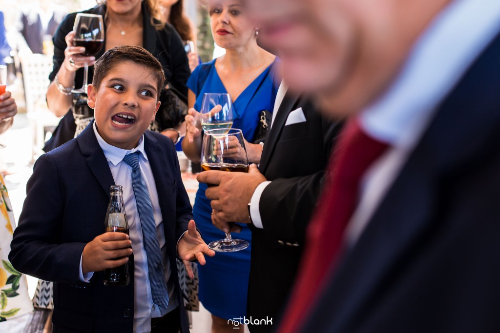 Boda en Quinta San Amaro en Meaño. El hijo del novio pone una mueca durante el cocktail. Reportaje realizado por Notblank fotógrafos de boda en Cangas.